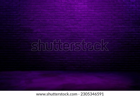 dark black brick wall background, rough concrete, plastered concrete floor, with neon purple glowing lights from above. lighting effect violet and blue on empty brick wall background for design.