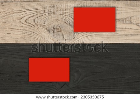 Blank red business cards on the Black wooden table. Template for ID. Top view