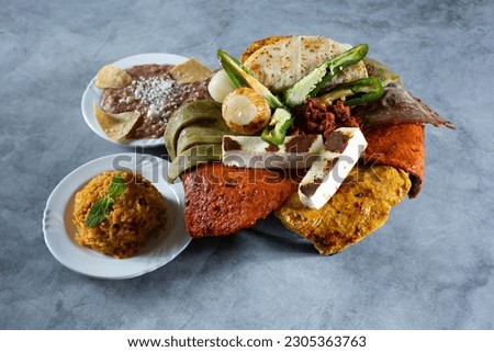 A view of a molcajete platter. Royalty-Free Stock Photo #2305363763