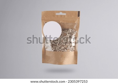 Craft packaging package with seeds levitating on a gray background with a shadow