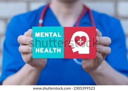 Doctor holding colorful blocks with icon of patient head and inscription: MENTAL HEALTH. Concept of mental health and problems with memory. Royalty-Free Stock Photo #2305399523