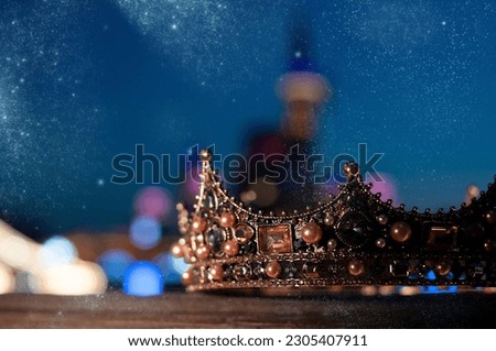 Luxury royal sparkle crown, night lights on castle background. Fairy tale