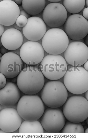 Indoor or outdoor wall decorated with many balloons as background. black and white photography