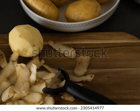 raw potatoes with peeled skin on the wooden desk on the table. High quality photo