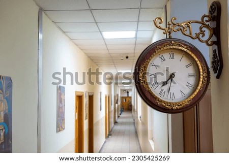 photo of wall clock and long corridor