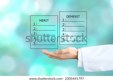 Doctor's hand and lists for merit and demerit
