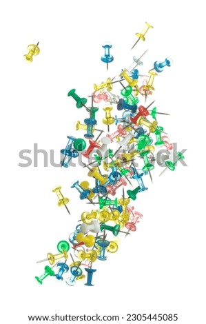 Push Pins in various color fly floating in mid air. Many group colour pins fall as office school stationary. Abstract pushpin explode unbox. White background isolated high speed shutter freeze motion