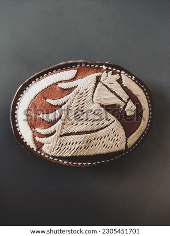 Cowboy belt buckle with horse print