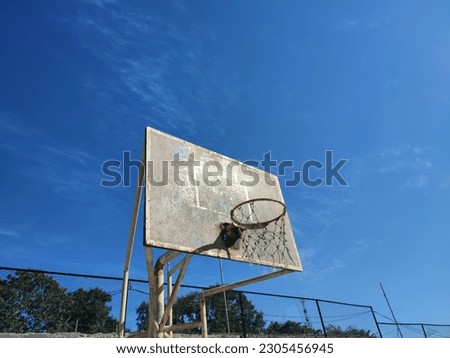 old and Aged basketball hoop on bright blue background