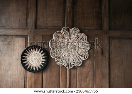 round rattan decoration, attached to a wooden wall