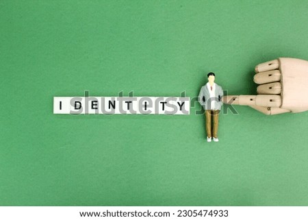 miniature people with the word Identity. the concept of a person's identity or a company's identity. Royalty-Free Stock Photo #2305474933