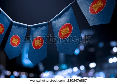 A garland of ASEAN national flags on an abstract blurred background. Royalty-Free Stock Photo #2305476887