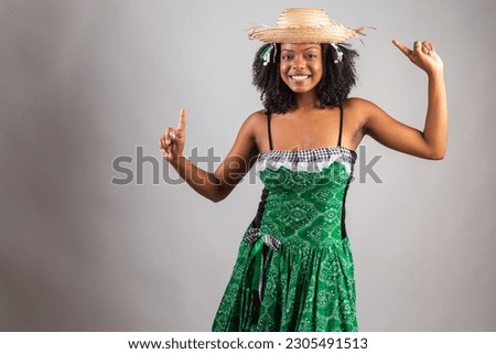 portrait, Black Brazilian woman in festa junina clothes. Saint John's festival. dancing.