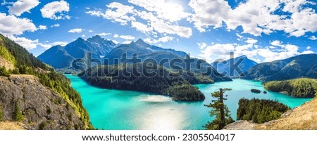 Panorama of a bright blue lake in North Cascades National Park. Royalty-Free Stock Photo #2305504017