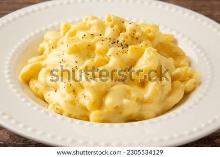 American macaroni cheese with cheddar cheese Royalty-Free Stock Photo #2305534129