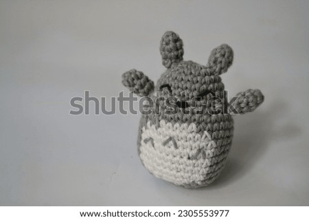 Klaten, May 18, 2023. Crochet handmade totoro doll standing on white background. Stuffed toy made from cotton yarn with crochet technique. Totoro is famous Japanese character.