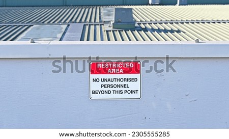 Restricted area no unauthorised personal beyond this point sign Royalty-Free Stock Photo #2305555285
