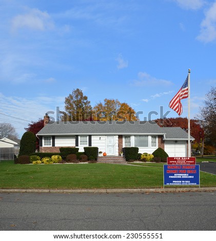 American Flag Pole Real Estate For Sale Open House Welcome sign suburban ranch style home residential neighborhood blue sky clouds USA