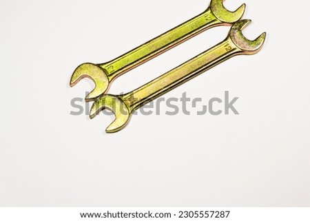 Two wrenches or spanners crossed on white backgorund for concept design. Repair service. Service concept. Pirate sign, motorcycle repair, bikers concept.