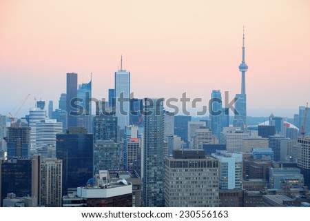 Toronto at dusk with city light and urban skyline with skyscrapers