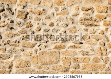 detail of a wall of irregular granite quarrying worn away, textured background Royalty-Free Stock Photo #2305567985