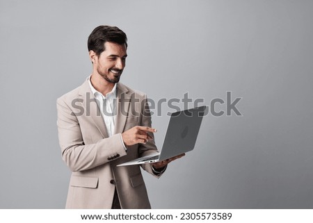 man suit beard laptop computer copyspace freelancer smiling internet job business Royalty-Free Stock Photo #2305573589