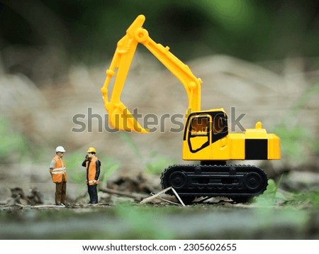 Toy photography concept. Unfocus brown grass at land. Background is blurred.