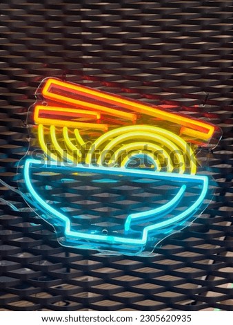 Illuminated noodle. Bright colored collection of symbols or sign boards glowing with colorful neon light for cafe, restaurant, motel or cocktail bar. Template layout on grid background, copy space.