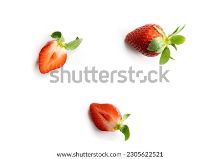 Strawberries on a white background. One whole berry and two halves of juicy fruit. Composition in the style of flat lay.