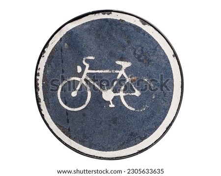 Top view of an asphalt manhole cover with stylized bicycles as a signpost isolated on white.