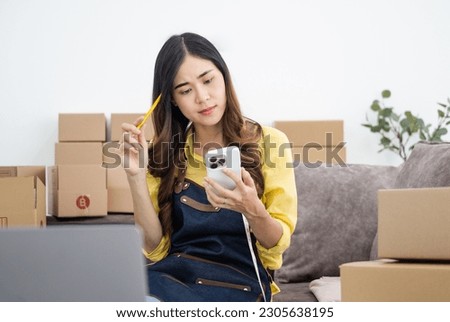 Asian woman think hard serious working laptop computer at home selling online start up small business owner, e-commerce ideas concept.