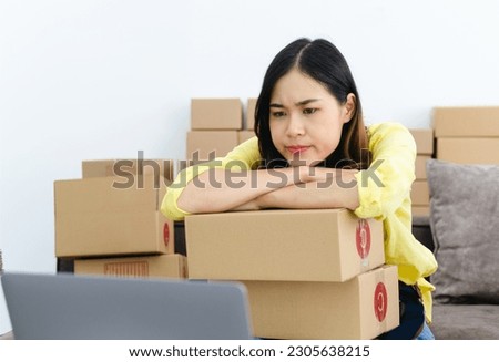 Asian woman think hard serious working laptop computer at home selling online start up small business owner, e-commerce ideas concept.