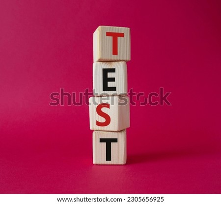 Test symbol. Concept word Test on wooden cubes. Beautiful red background. Business and Test concept. Copy space.