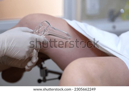 The gynecologist takes a vaginal swab for bacterial examination. Gynecological chair. A woman at the gynecologist for a check-up.  Royalty-Free Stock Photo #2305662249