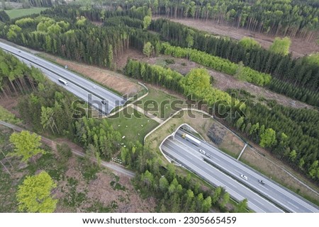 Aerial panorama view of ecoduct or wildlife crossing - vegetation covered bridge over a motorway that allows wildlife to safely cross over,wildlife crossing over busy highway,animal overpass Royalty-Free Stock Photo #2305665459