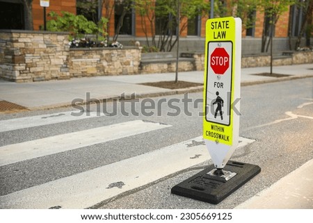 Navigating life's journey with the pedestrian sign. A symbol of safety, shared spaces, and the importance of pedestrian rights and awareness Royalty-Free Stock Photo #2305669125