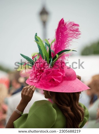 Elegant hats and fancy attire at the horse races  Royalty-Free Stock Photo #2305688219