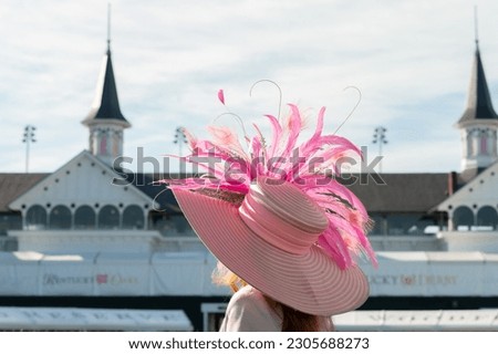 Elegant hats and fancy attire at the horse races  Royalty-Free Stock Photo #2305688273