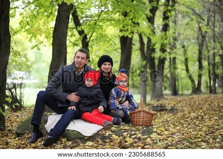 Young family with children on a walk in the park in spring
