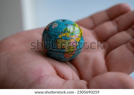 closeup photo of world globe in a hand