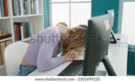 Young beautiful hispanic woman student using computer tired at library university