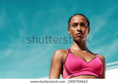 Sports, fitness and serious woman with blue sky mockup at outdoor gym for health and wellness. Workout, exercise and female athlete with focus, power and healthy mindset for summer goals with space. Royalty-Free Stock Photo #2305704663