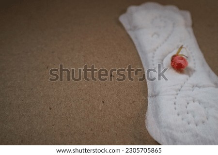 Daily women's gasket on brown background. copy space. soft focus. White cotton panty liner, sanitary pad on white background, top view, flat lay, minimalism. Menstrual cycle. Women's hygiene.