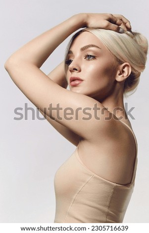 Portrait of a young blonde woman with natural makeup and natural styling. Advertising of natural cosmetics. Beauty salon advertisement. Care cosmetics, face and body skin care. Royalty-Free Stock Photo #2305716639