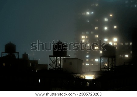 Dense nightime fog covers Manhattan rooftops