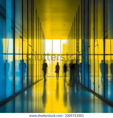 Office employees in a blue and yellow business building, their silhouettes blurred. Royalty-Free Stock Photo #2305723301
