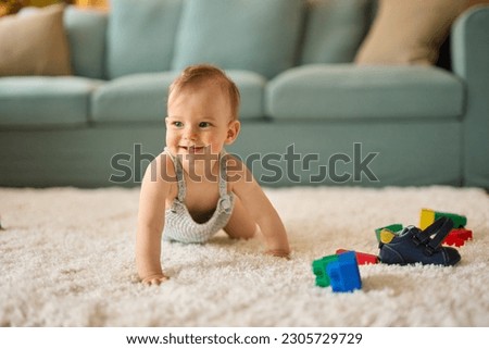 Portrait of a cute crawling baby boy at home Royalty-Free Stock Photo #2305729729