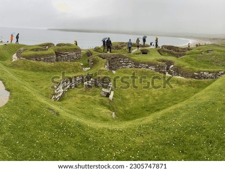 Skara Brae on the Bay of Skaill on the west coast of Mainland, in the Orkney. View to a stone-built Neolithic settlement. Royalty-Free Stock Photo #2305747871