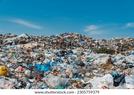 Garbage dump landscape. Open-air landfill. Ecological damage, contaminated land. Royalty-Free Stock Photo #2305759379