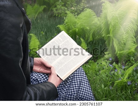 Pretty cute happy adult human rest relax look spring day open page closeup top view yard grass space. Child kid lady retro holy paper pad old Christ god gospel script church history note ancient idea